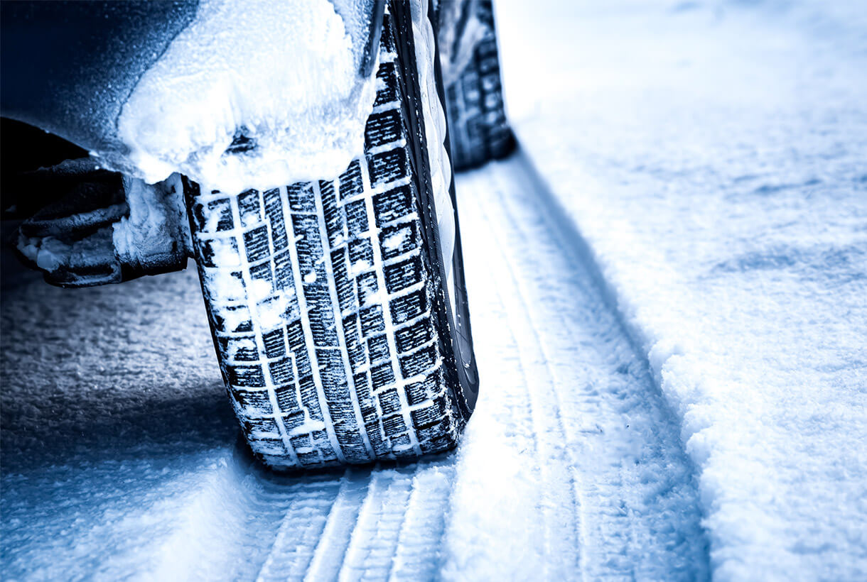 Photo of a snow covered vehicle driving on a snowy road